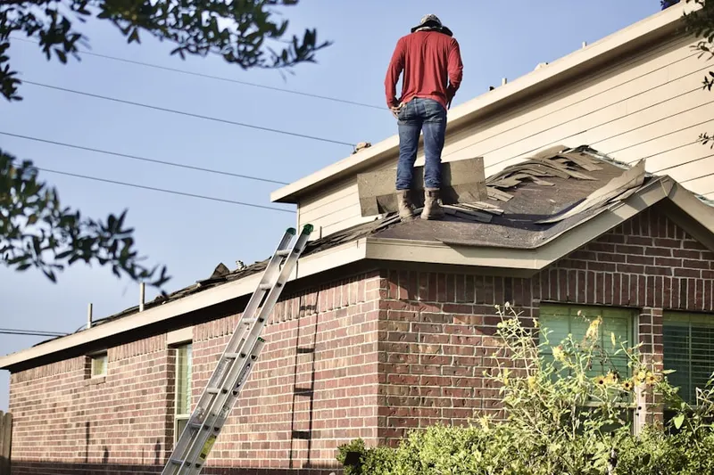 Professional roofer working on a residential roof in Brandywood